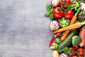 Flat lay of various colorful raw vegetables.